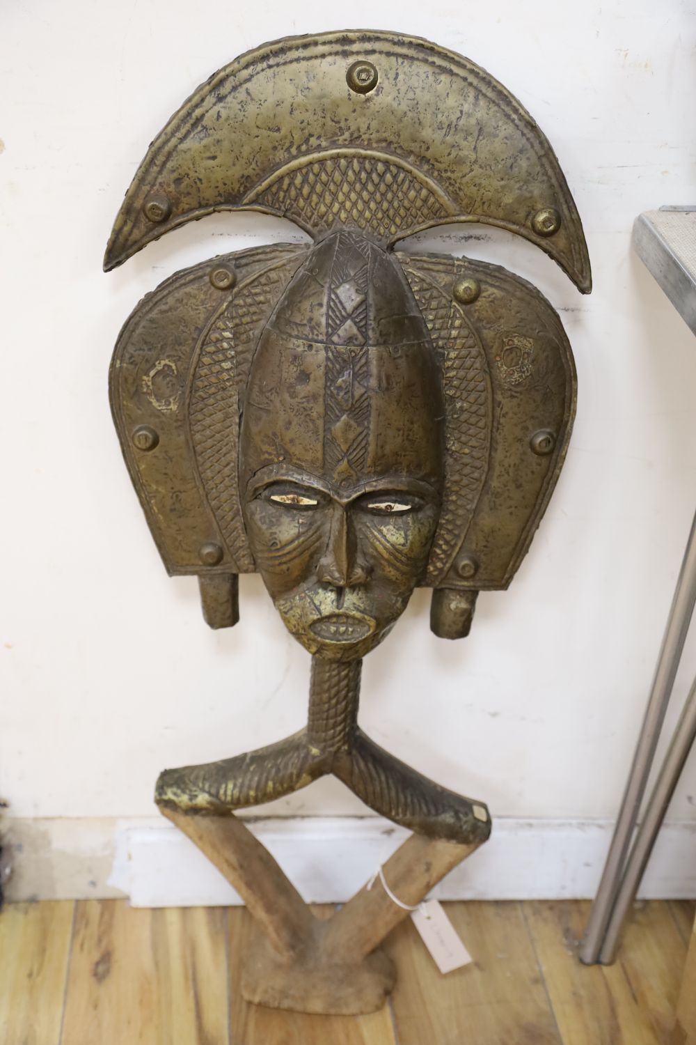 A large African tribal metal overlaid wood mask, length 90cm